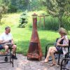 67c6ec5d-2c06-44bd-8a9c-fafa10b71236.c4ae3cbcec75f9f5c5479f81b1e9efc8.jpg Sunnydaze 70″ Rust Patina Finish Steel Wood-Burning Chiminea with Spark Screen
